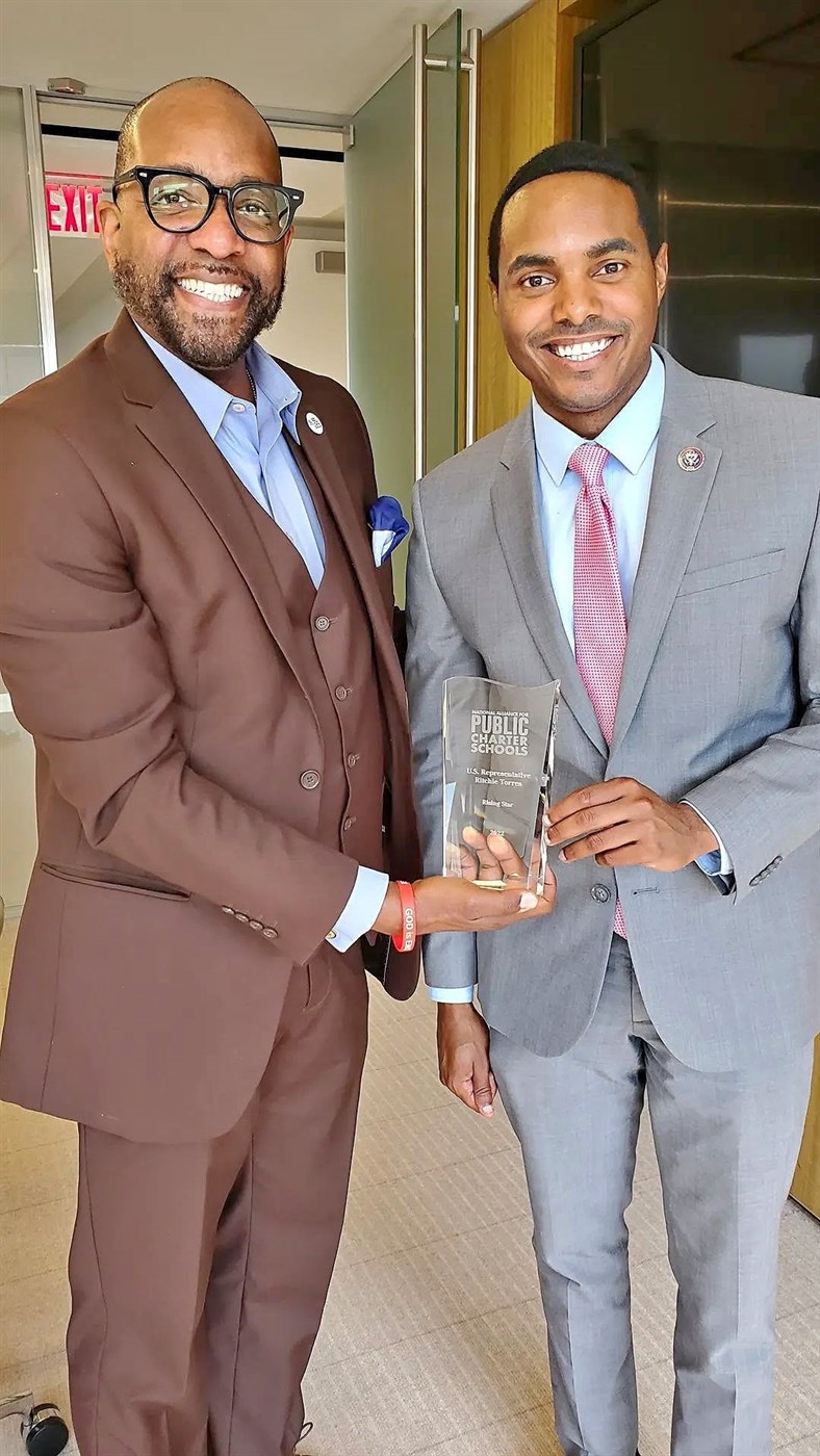 Ronald C. Rice and Rep. Ritchie Torres holding an award